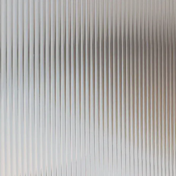 Fluted glass panel casting intricate shadows